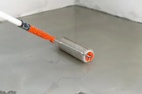 Self-leveling epoxy. Leveling with a mixture of cement floors. Stock Photos