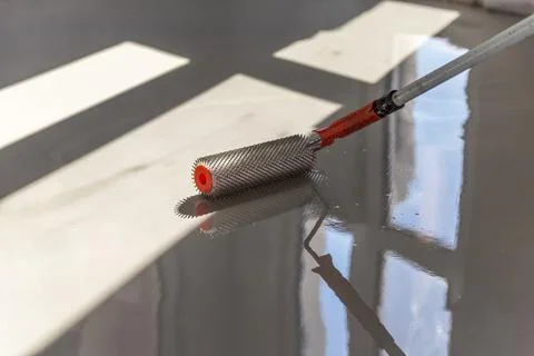 Self-leveling epoxy. Leveling with a mixture of cement floors. Stock Photos