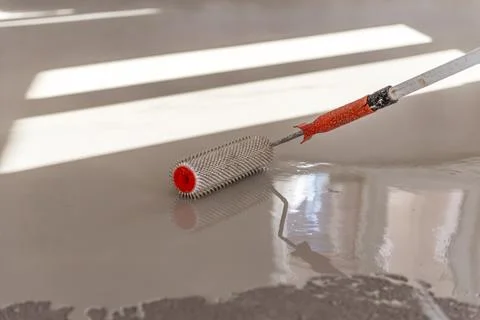 Self-leveling epoxy. Leveling with a mixture of cement floors. Stock Photos