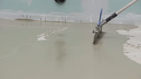 Self leveling screed - spreading the material Stock Footage 111939150