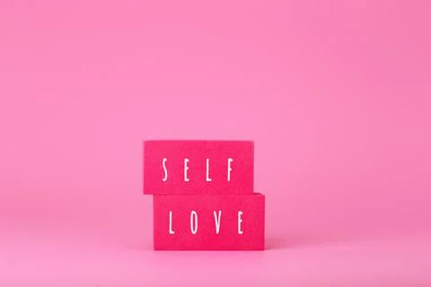 Self love minimal creative concept in pink colors against pink background with Stock Photos