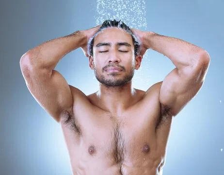 Self-love takes priority. Studio shot of a handsome young man washing his hair Stock Photos