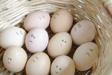 Self Made Hand Drawn - Group of emotional eggs. They are in a basket . Stock Photos
