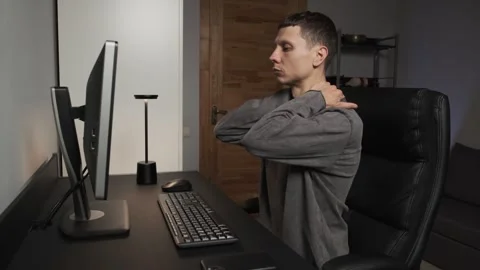 Self massage during computer work man massaging neck shoulders head arms Stock Footage 315411791