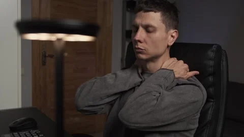 Self massage during computer work man massaging neck shoulders head arms Video stock 315665395