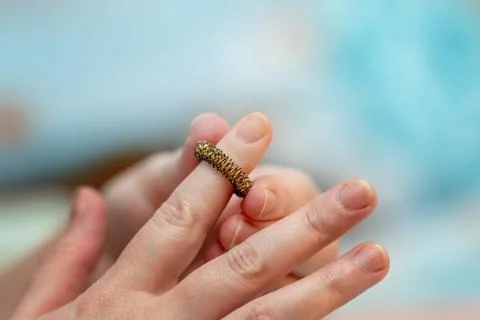 Self-massage of index finger using a Su-Jok metal spring ball for acupressu.. Stock Photos