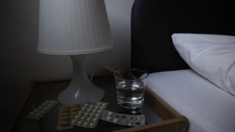 Self-medication concept. Sick Man Sleeping Bad In Bed, Pharmacy Glass Of Water Stock Footage 89561101