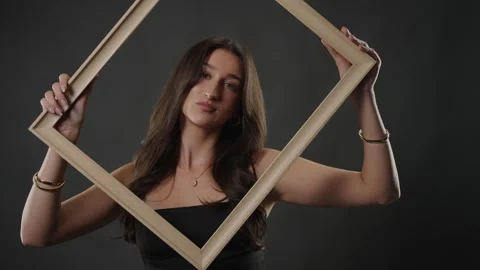 Self-perception and identity concept, young woman holding empty frame, beauty Stock Footage 336936824
