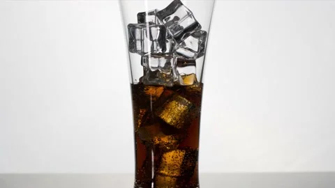 Self pouring cola to the glass with ice in slide movement, stop motion Stock Footage