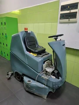 Self-propelled floor scrubber with operator seat. Ride-on floor scrubber machine Photos