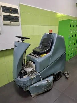 Self-propelled floor scrubber with operator seat. Ride-on floor scrubber machine Stock Photos