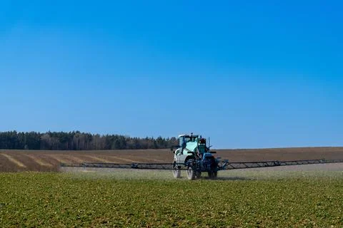 A self-propelled high-maintenance sprayer applies liquid fertilizers Stock Photos