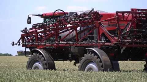 Self propelled sprayer with big clearance is driving on the wheat field Stock Footage 138138591