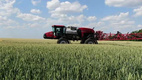 Self propelled sprayer is driving across the field, a boom over the camera Stock Footage 138138760