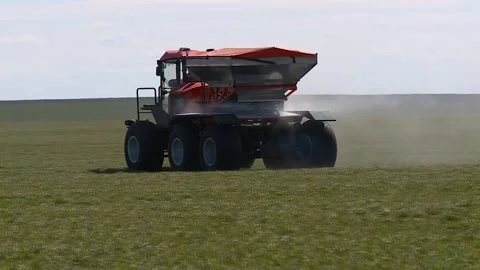 Self propelled sprayer fertilizer spreader rides on a green field Stock-Footage 130269232