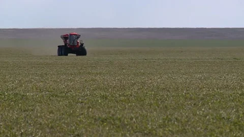 Self propelled sprayer fertilizer spreader rides on a green field Stock-Footage 130269251