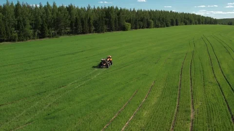 Self-propelled sprayer-spreader of orange color works on the field Stock Footage 271477918