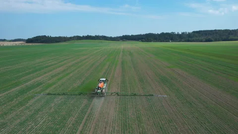 Self-propelled sprayer working on the field, top view from behind. Stock Footage 167526932