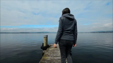 Self-reflection. Figure on the pier.  Lake Shore. Stock Footage 82902466