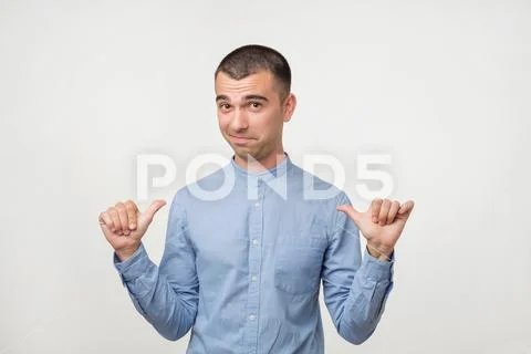 Self-satisfied and proud young man looks forward Stock Photos