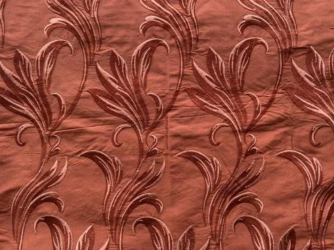 Self Self Rust thread floral embroidery on linear style on rust silk fabric Stock Photos