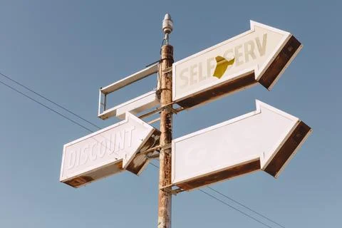 Self Serve sign, three arrows on an elevated roadside sign. Stock Photos