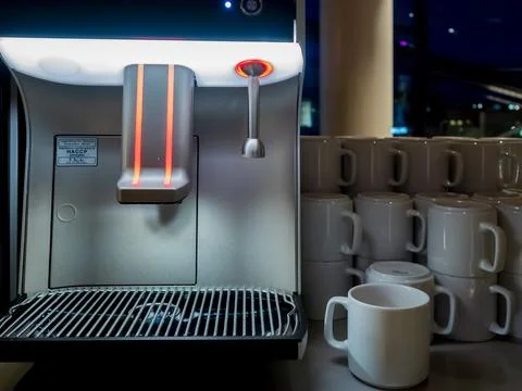 Self-service automatic coffee making machine with ceramic cups Stock Photos