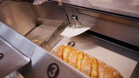 Self service bread slicer machine in grocery store, customer hand in dispos.. Stock Footage 331799700