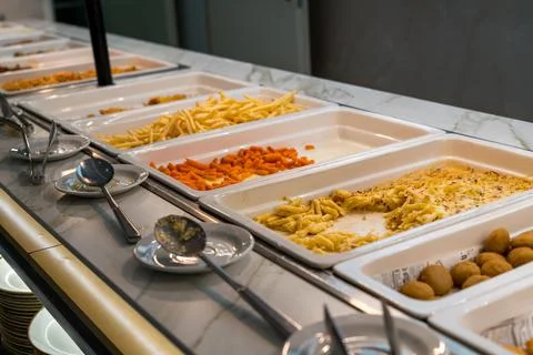 Self service buffet counter with hot dishes and french fries trays Stock Photos