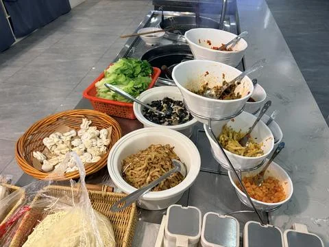 Self-Service Buffet with Fresh Vegetables and Condiments 스톡 사진