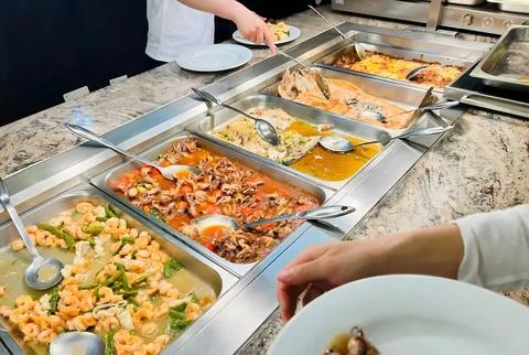 Self-Service Buffet Station with Various Hot Seafood Dishes Including Shrim.. Stock Photos
