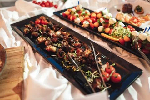 Self-service buffet table with various types of small snacks. Focused on bacon Stock Photos