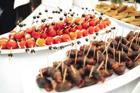 Self-service buffet table with various types of small snacks. Focused on stuffed Stock Photos