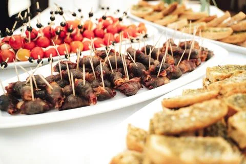 Self-service buffet table with various types of small snacks. Focused on bacon Stock Photos