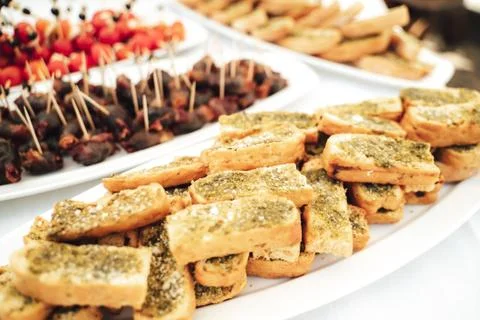 Self-service buffet table with various types of small snacks. Focused on Stock Photos
