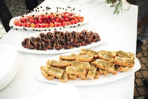 Self-service buffet table with various types of small snacks. Celebration Stock Photos