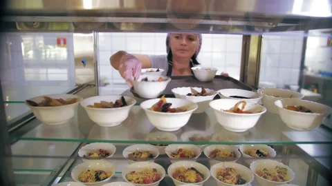 Self-service cafeteria. buffet restaurant. the waitress puts salads in small Stock Footage 168533695