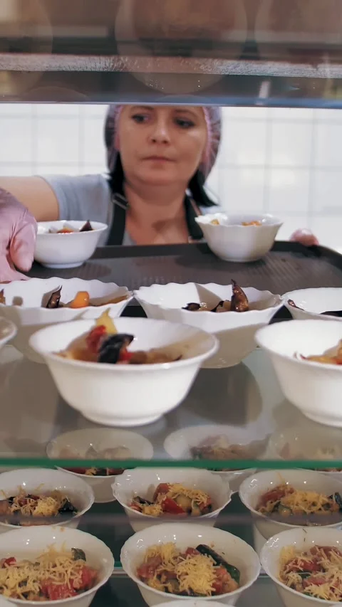 Self-service cafeteria. buffet restaurant. the waitress puts salads in small Stock Footage 318145077