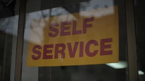 Self Service Sign in A Business Window Stock Footage 191165341