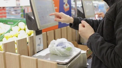 Self service in the supermarket: man using weight scales buying fresh fruits Stock Footage 75523735