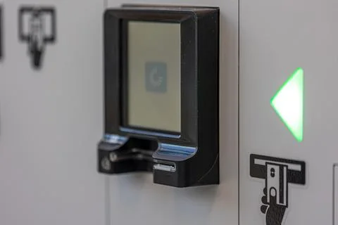 Self-service terminal with a loading screen. A payment device displays a pr.. Stock Photos