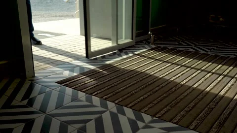 Self-sliding doors open to allow customers to enter the store. Close-up Stock Footage 154674850