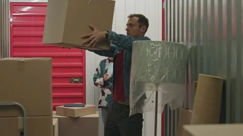 Self Storage Worker Using Digital Tablet and Instructing Client Stock Footage 259827905