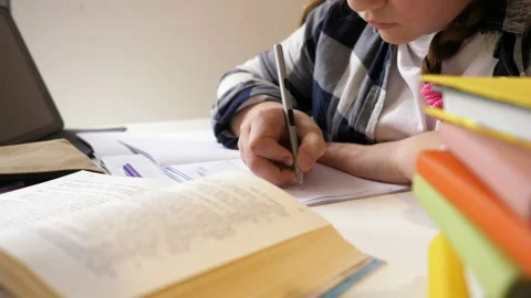 Self-study activities. Girl is doing homework. Close-up. Stock Footage 128377239