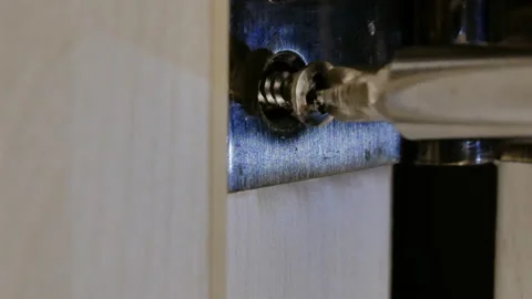 Self tapped screw is screwed in a door hinge Stock Footage 145758341