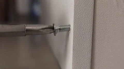 Self-tapping screw being driven into a plywood board using an electric drill Stock Footage 326063811