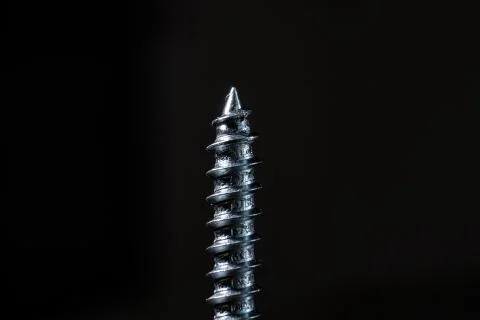 The self-tapping screw on black background. Copy space Stock Photos