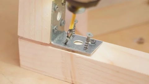 The self-tapping screw is twisted crookedly into a wooden beam close-up. The Stock Footage 167619887