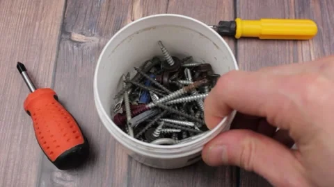 Self-tapping screws and screwdriver. Set of tools. Screwdrivers and screws. Stock Footage 174968172