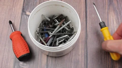 Self-tapping screws and screwdriver. Set of tools. Screwdrivers and screws. Stock Footage 174968691